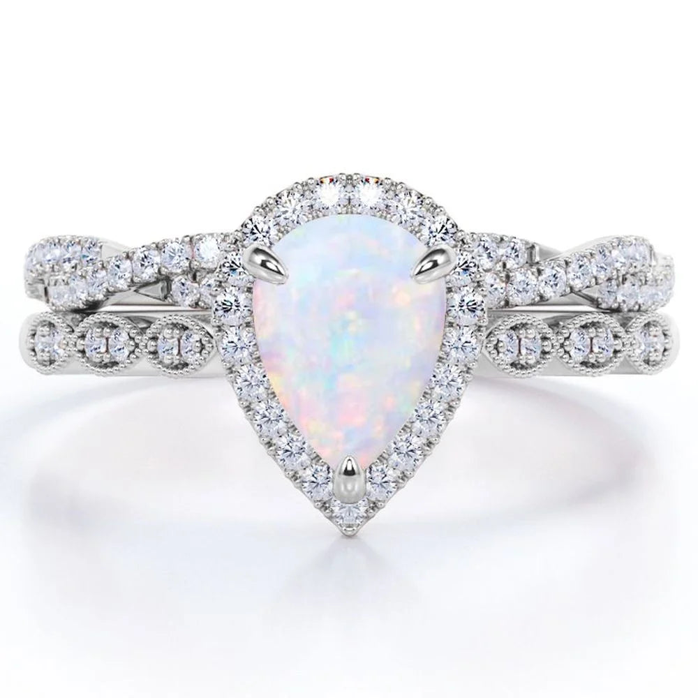 Opaline Vintage Bridal Ring Set — pear-cut lab-created opal and moissanite halo engagement ring with pavé band, House of Ugarit
