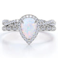 Opaline Vintage Bridal Ring Set — pear-cut lab-created opal and moissanite halo engagement ring with pavé band, House of Ugarit