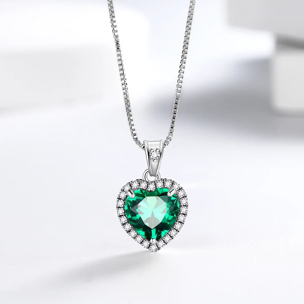 Emerald Heart Necklace detail — emerald-green heart pendant close-up, House of Ugarit