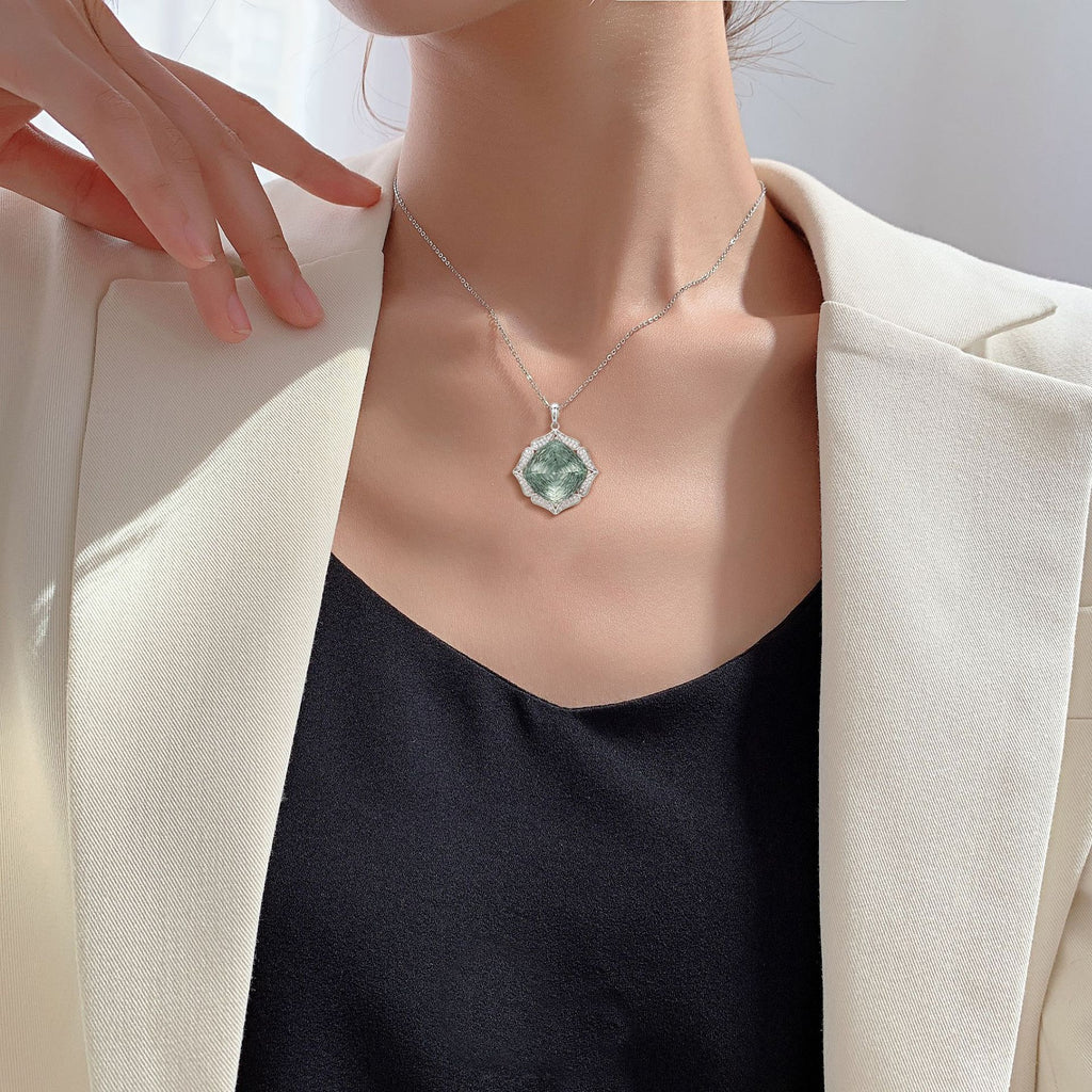 Emerald Isle Luxury Pendant Necklace — light green stone under light, House of Ugarit